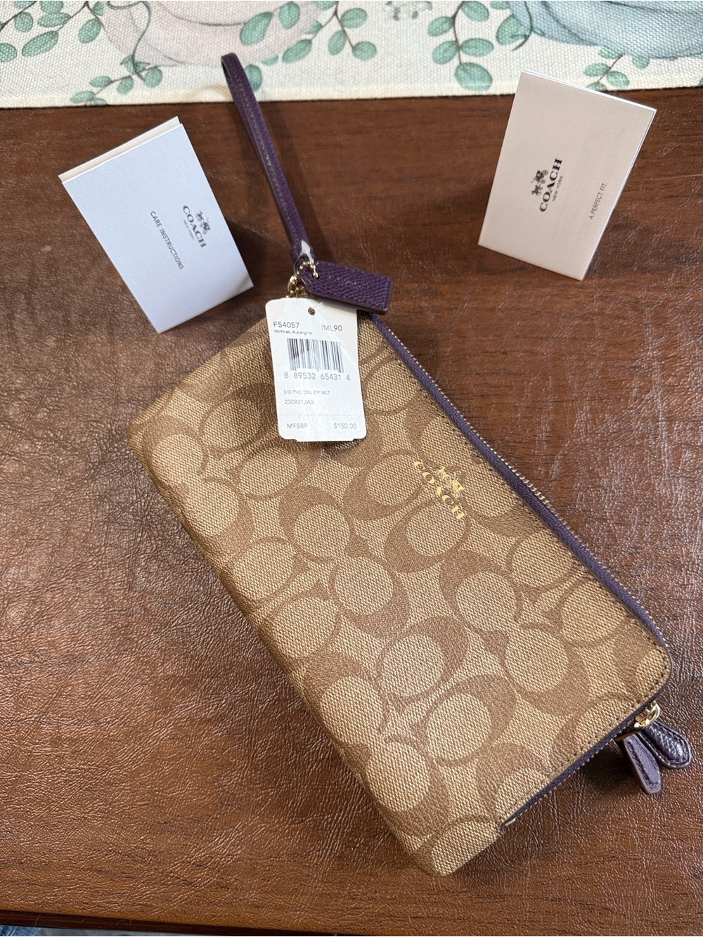 Coach Tan Signature Canvas Wristlet with Aubergine (deep purple) Trim. Beautiful
